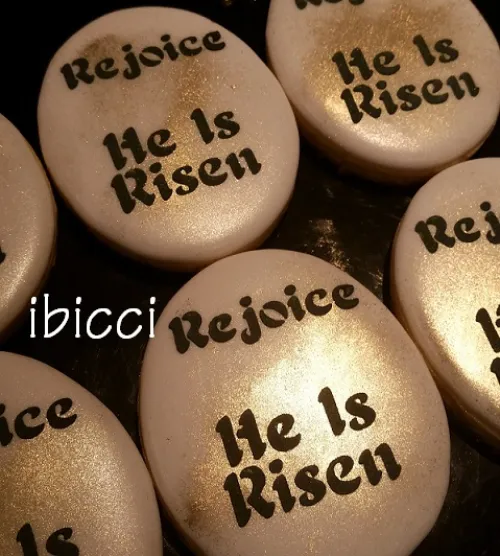 Night shot of ibicci 3" oval cookies using the Easter Rejoice, He is Risen stencil